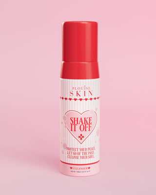 A pump bottle of P.Louise Shake It Off Foaming Face Cleanser against a pink background, with product information and branding visible on the bottle.