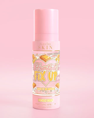 Pink bottle of P. Louise Skin Breakfast Frosted Fix Up Blurring Setting Spray in French Toast scent infused with skincare on a pink background