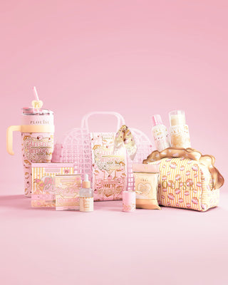 Collection of P.Louise skincare and body care items plus a water bottle and boo basket basket on a pink background